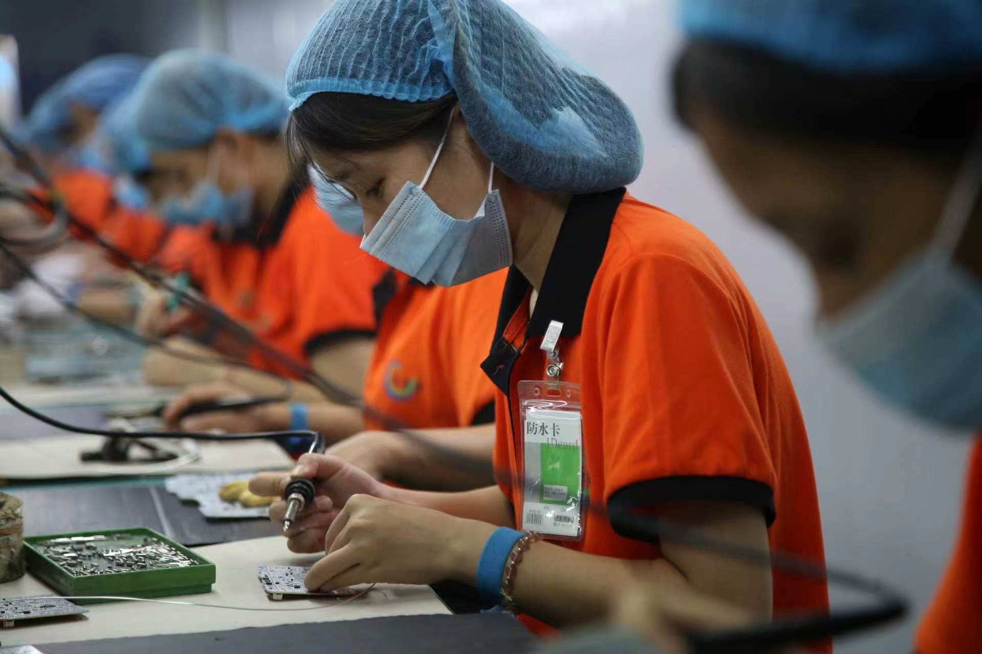 Production operator working on electronic assembly