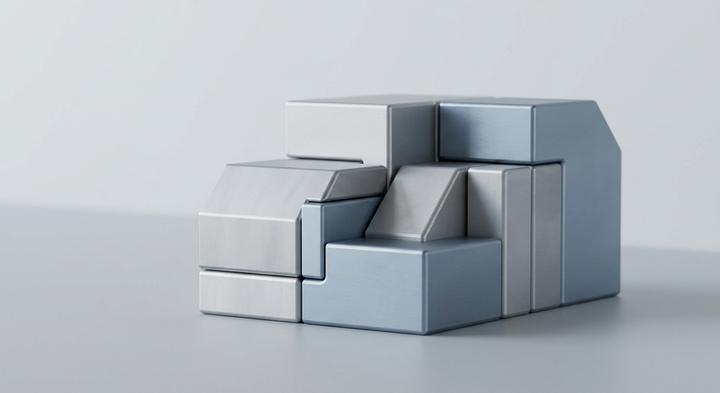 Abstract geometric steel molds fitting together, representing custom tooling and production scale.