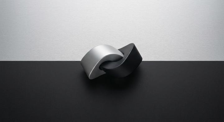 Minimalist split view of anodized aluminum and smooth matte polymer textures showing high-quality industrial substrates