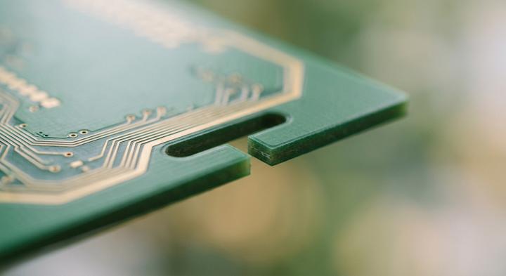 Minimalist close-up of a modern circuit board with routed thermal isolation slot