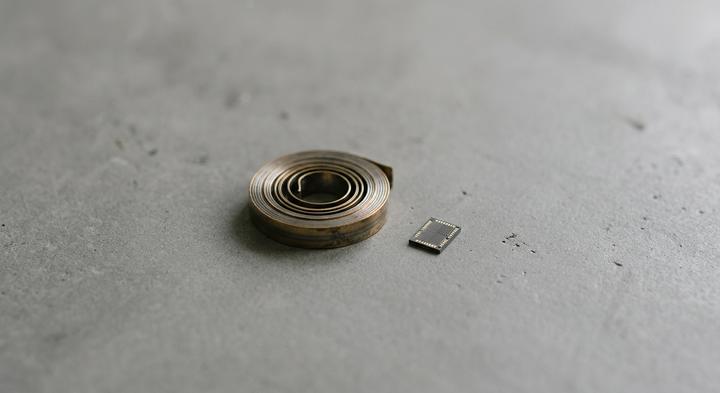 Abstract comparison of raw bimetallic coil and silicon chip technologies