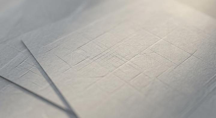 Abstract design blueprint with embossed geometric lines and grid marks indicating high-precision packaging engineering