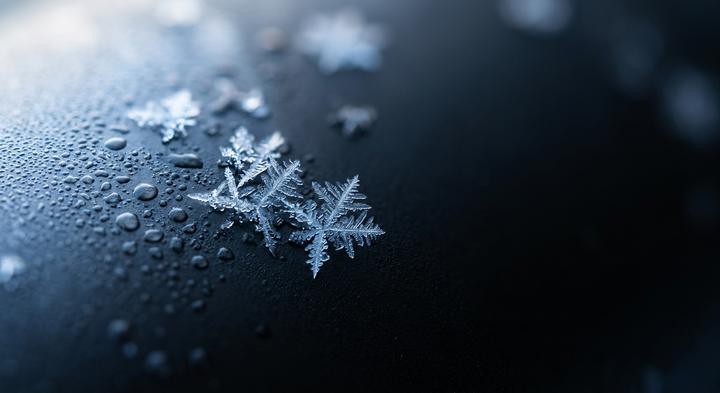 Macro shot of abstract condensation and frost transition on a surface representing thermal stress